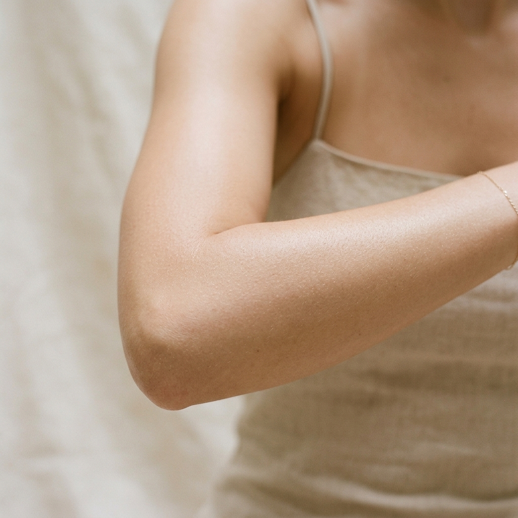 Why do elbows become darker with age?